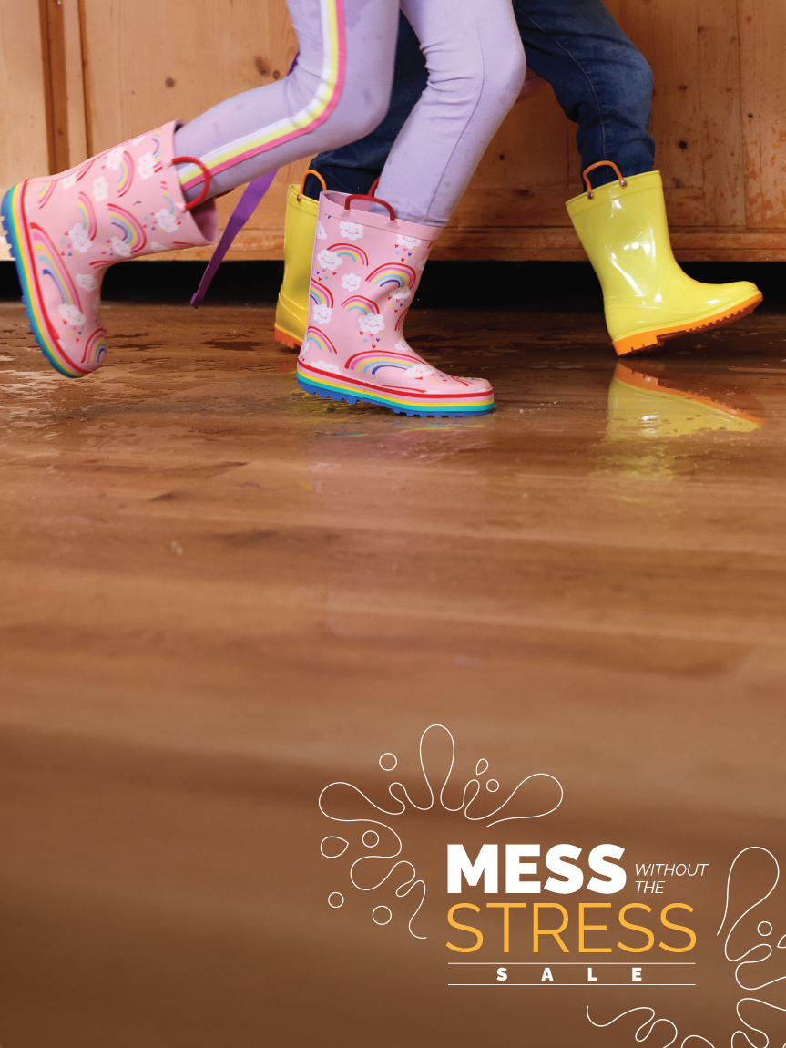 Kids playing in rain boots on luxury vinyl flooring.